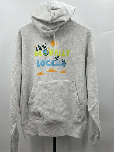 A light heather gray pullover hoodie displayed on a mannequin torso against a plain light gray background. The front of the hoodie features a colorful graphic print that reads 'think GLOBALLY and LOCALLY' with a sun, clouds, and peace sign.