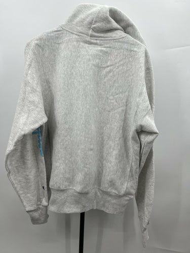A light gray heathered hoodie sweatshirt shown from the back, hanging on a black stand against a light gray background.
